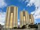 Three high rise buildings with golden glass windows and blue sky at 125 E Harmon Ave # 1003, Las Vegas, NV 89109