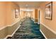 Inviting hallway featuring decorative carpeting, neutral walls, and art at 125 E Harmon Ave # 1003, Las Vegas, NV 89109