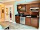 Modern kitchenette with stainless steel appliances, sleek cabinets, and convenient access to the bathroom at 125 E Harmon Ave # 1003, Las Vegas, NV 89109