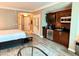 Open living space with kitchenette, featuring stainless steel appliances and hardwood floors at 125 E Harmon Ave # 1003, Las Vegas, NV 89109