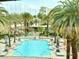 Beautiful pool with palm trees and lounge chairs at 125 E Harmon Ave # 1003, Las Vegas, NV 89109