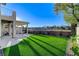Expansive backyard with a covered patio, artificial turf, and beautiful mountain views at 1317 Fox Acres Dr, Las Vegas, NV 89134