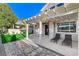 Inviting backyard patio with a pergola, stone pavers, lawn, and stylish lounge chairs for relaxing outdoors at 1317 Fox Acres Dr, Las Vegas, NV 89134