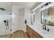 This bathroom has a double vanity, glass block windows, and a glass shower at 1317 Fox Acres Dr, Las Vegas, NV 89134