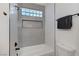 A tiled shower-tub combo featuring a glass block window and niche at 1317 Fox Acres Dr, Las Vegas, NV 89134