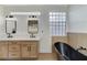 This bathroom has a double sink vanity, a tub, and a frosted glass window at 1317 Fox Acres Dr, Las Vegas, NV 89134
