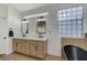 This bathroom has a double vanity, a standalone tub and frosted glass block windows at 1317 Fox Acres Dr, Las Vegas, NV 89134