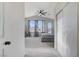 This bedroom has a ceiling fan, three windows, and a door that leads to a balcony at 1317 Fox Acres Dr, Las Vegas, NV 89134