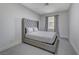 Comfortable bedroom featuring neutral tones, carpet flooring, and a large window at 1317 Fox Acres Dr, Las Vegas, NV 89134