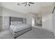This bedroom has a ceiling fan and is carpeted. It has a tall headboard at 1317 Fox Acres Dr, Las Vegas, NV 89134