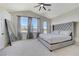 The primary bedroom features soft carpet, a gray tufted headboard, and great natural light at 1317 Fox Acres Dr, Las Vegas, NV 89134