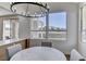 Dining area features mountain views, stylish chandelier, and seating, blending indoor and outdoor ambiance at 1317 Fox Acres Dr, Las Vegas, NV 89134
