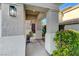 Inviting home entrance with decorative light fixture, concrete walkway, and manicured landscaping at 1317 Fox Acres Dr, Las Vegas, NV 89134