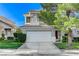 Attractive two-story home with a tile roof, mature landscaping, and a two-car garage at 1317 Fox Acres Dr, Las Vegas, NV 89134
