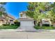 Lovely two-story home with a well-manicured lawn, mature trees, and an attached two-car garage at 1317 Fox Acres Dr, Las Vegas, NV 89134