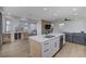 Modern kitchen featuring a large island, wine storage, and an open layout, perfect for entertaining and cooking at 1317 Fox Acres Dr, Las Vegas, NV 89134