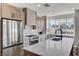 Modern kitchen featuring stainless steel appliances, a large island, and mountain views from the window at 1317 Fox Acres Dr, Las Vegas, NV 89134