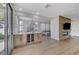 Spacious living room with built-in bar, wine fridge, fireplace, and sliding door access to the outdoors at 1317 Fox Acres Dr, Las Vegas, NV 89134