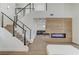 Bright living room featuring a modern fireplace, staircase, and open floor plan, creating an inviting space at 1317 Fox Acres Dr, Las Vegas, NV 89134