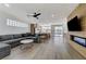 Open concept living space featuring modern fireplace and seamless flow into the kitchen, and a gray sofa at 1317 Fox Acres Dr, Las Vegas, NV 89134