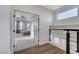 View from hallway into the main bedroom with a ceiling fan and large windows, creating a bright, airy space at 1317 Fox Acres Dr, Las Vegas, NV 89134