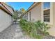 Home side yard features a stone pathway, mature landscaping, and low-maintenance features at 1317 Fox Acres Dr, Las Vegas, NV 89134