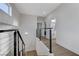 Bright upstairs hallway features modern railing and a view of a well-lit bathroom creating an airy feel at 1317 Fox Acres Dr, Las Vegas, NV 89134