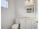 Well-lit bathroom features a vanity with a cream countertop, white cabinets, and modern fixtures for a clean, inviting space at 1329 Jewelstone Cir, Henderson, NV 89012