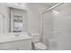 Bright bathroom featuring a white vanity, toilet, and glass-enclosed shower with tile surround at 1329 Jewelstone Cir, Henderson, NV 89012