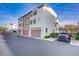 Modern townhome exterior with stucco facade, garages, and landscaping. A stylish and convenient place to call home at 1329 Jewelstone Cir, Henderson, NV 89012