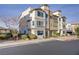 Attractive multi-level townhome featuring a stucco exterior, well-maintained landscaping, and convenient parking at 1329 Jewelstone Cir, Henderson, NV 89012