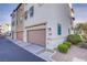 Contemporary townhome garage featuring a stucco exterior, low maintenance landscaping, and convenient access to the neighborhood at 1329 Jewelstone Cir, Henderson, NV 89012