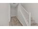 Clean, neutral hallway with wood-look floors and a staircase for easy access to the upper levels at 1329 Jewelstone Cir, Henderson, NV 89012