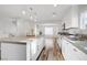 Bright and open kitchen featuring an island, stainless steel appliances, and wood floors at 1329 Jewelstone Cir, Henderson, NV 89012