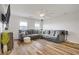 Cozy living room features a large sectional sofa, modern decor, and wood floors at 1329 Jewelstone Cir, Henderson, NV 89012