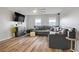 Spacious living room features a large sectional sofa, modern decor, and wood floors at 1329 Jewelstone Cir, Henderson, NV 89012