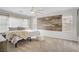 Large bedroom featuring stylish wood accent wall, large windows, and comfortable seating at 1329 Jewelstone Cir, Henderson, NV 89012