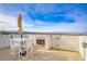 Outdoor patio with an incredible view, a fireplace, and contemporary white furniture at 1329 Jewelstone Cir, Henderson, NV 89012