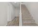 Well-lit staircase features carpeted steps and white handrail, creating an inviting transition between floors at 1329 Jewelstone Cir, Henderson, NV 89012
