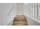 Bright staircase with modern white railing and natural wood steps. A clean design offering a seamless transition between floors at 1329 Jewelstone Cir, Henderson, NV 89012