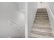 Bright stairway features carpeted stairs and a modern white handrail at 1329 Jewelstone Cir, Henderson, NV 89012