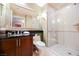 Modern bathroom with sleek vanity, a large mirror, toilet and walk-in shower with glass door at 145 Harmon Ave # 1021, Las Vegas, NV 89109