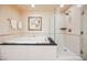 Bright bathroom showcasing both soaking tub and glass-enclosed shower at 145 Harmon Ave # 1021, Las Vegas, NV 89109