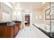 Modern bathroom with vanity, soaking tub, shower, and view into the bedroom at 145 Harmon Ave # 1021, Las Vegas, NV 89109