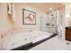 Luxurious bathroom featuring a deep soaking tub and glass-enclosed shower at 145 Harmon Ave # 1021, Las Vegas, NV 89109