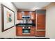 Lovely kitchen with wood cabinetry, stainless steel appliances, and stone countertops at 145 Harmon Ave # 1021, Las Vegas, NV 89109