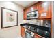 Cozy kitchen featuring stainless steel appliances, wood cabinets, and stylish countertops at 145 Harmon Ave # 1021, Las Vegas, NV 89109