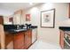 Stylish kitchen featuring wood cabinets, stainless steel appliances, and dark countertops at 145 Harmon Ave # 1021, Las Vegas, NV 89109