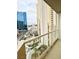 Balcony view featuring cityscape views of buildings and palm trees in a sunny urban setting at 145 W Harmon Ave # 1105, Las Vegas, NV 89109