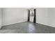This bedroom has gray wood-look floors, window with bars and dark drapes at 1520 Teton St, Las Vegas, NV 89101